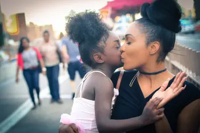 A mother holding a child, children skin is Sensitive, and needs to be taken care of more.