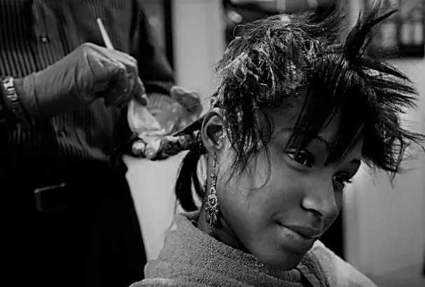 a woman getting some chemical in her hair