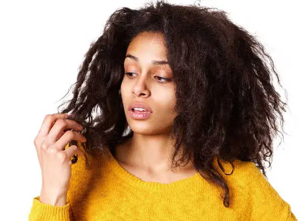 A woman worried about her hair breakage